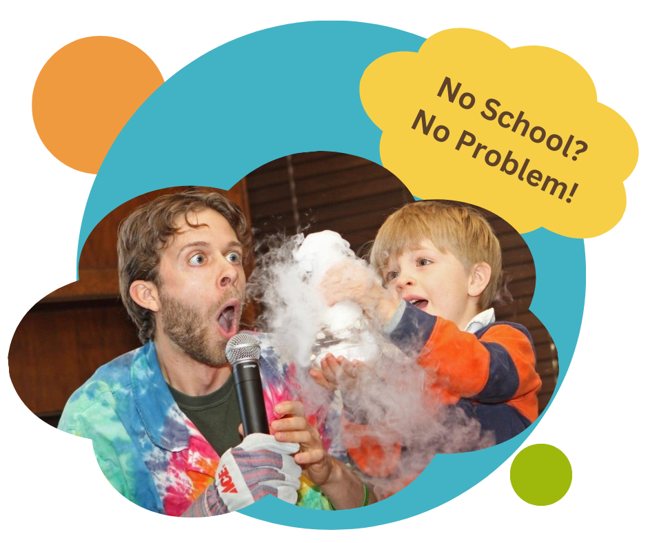 A Science Hero watches in exaggerated surprise as a child holds a beaker of dry ice. Captioned "No School? No Problem!"